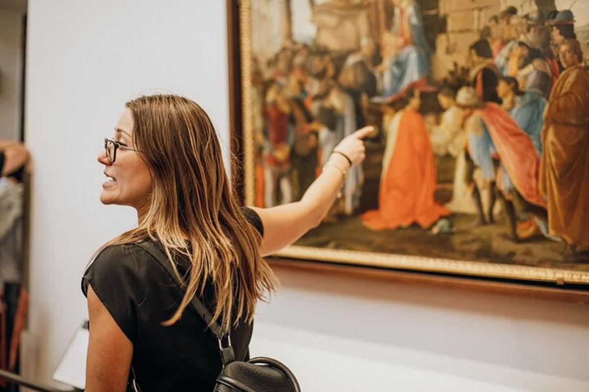 a woman pointing to a painting in a museum
