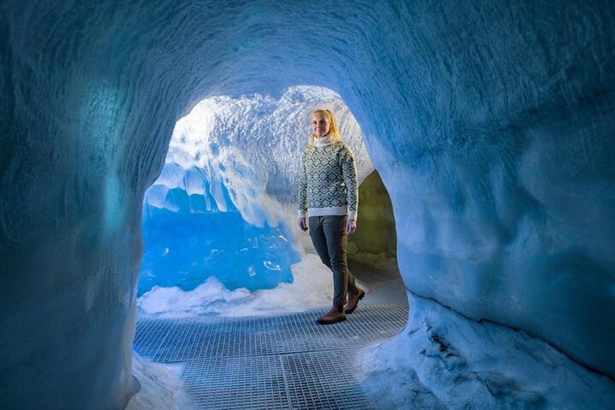 a woman standing inside of an ice cave