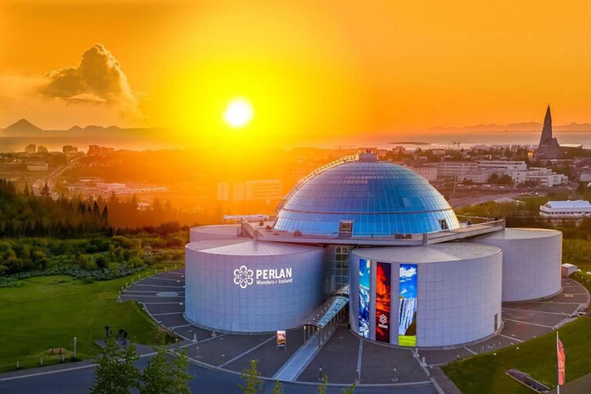 a picture of a building with the sun setting behind it