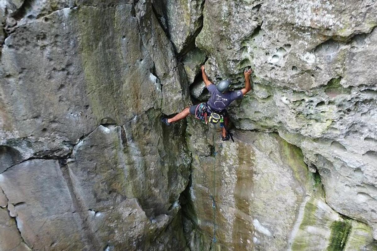 a man is rock climbing on a rock wall