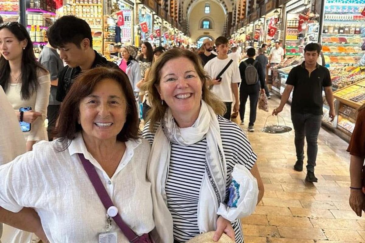 two women are standing in a grocery store
