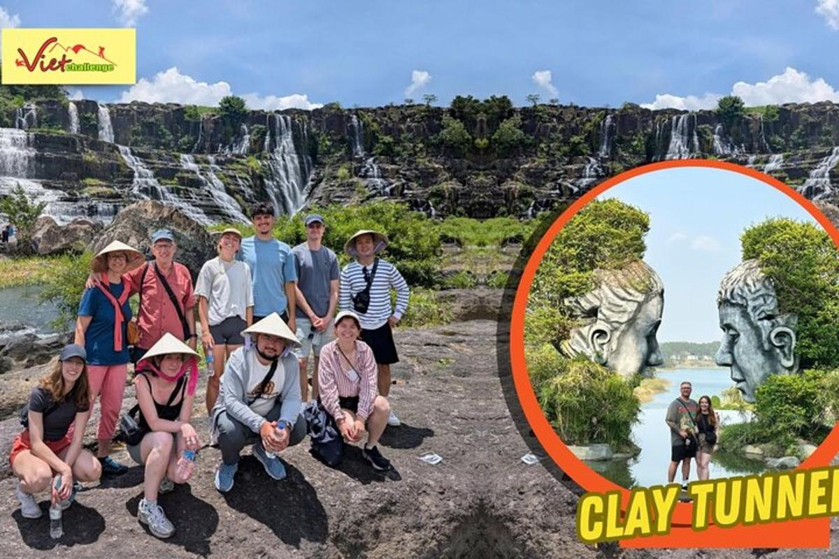 a group of people posing for a picture in front of a waterfall