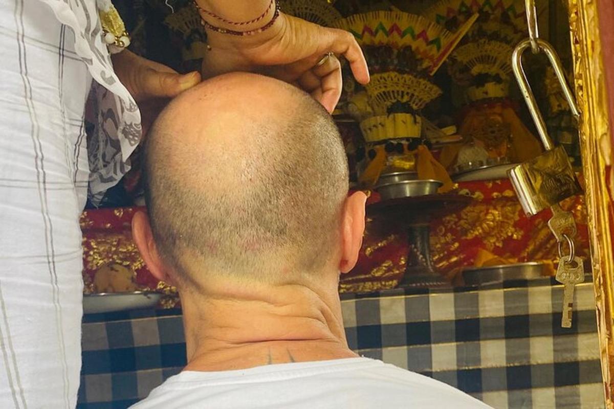 a man getting his hair cut by a barber