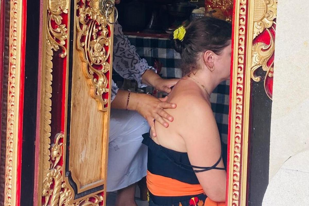 a woman looking at her back in front of a mirror