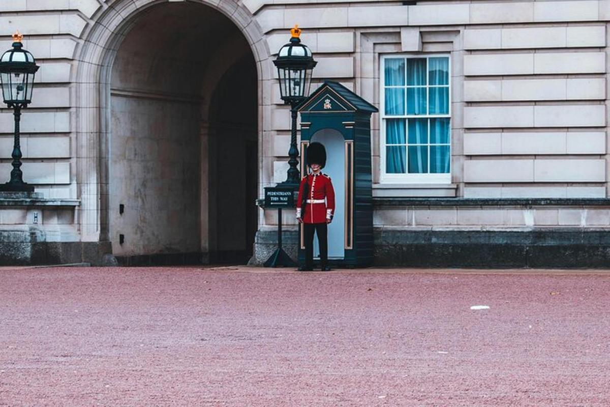 a man in a red coat standing in front of a building