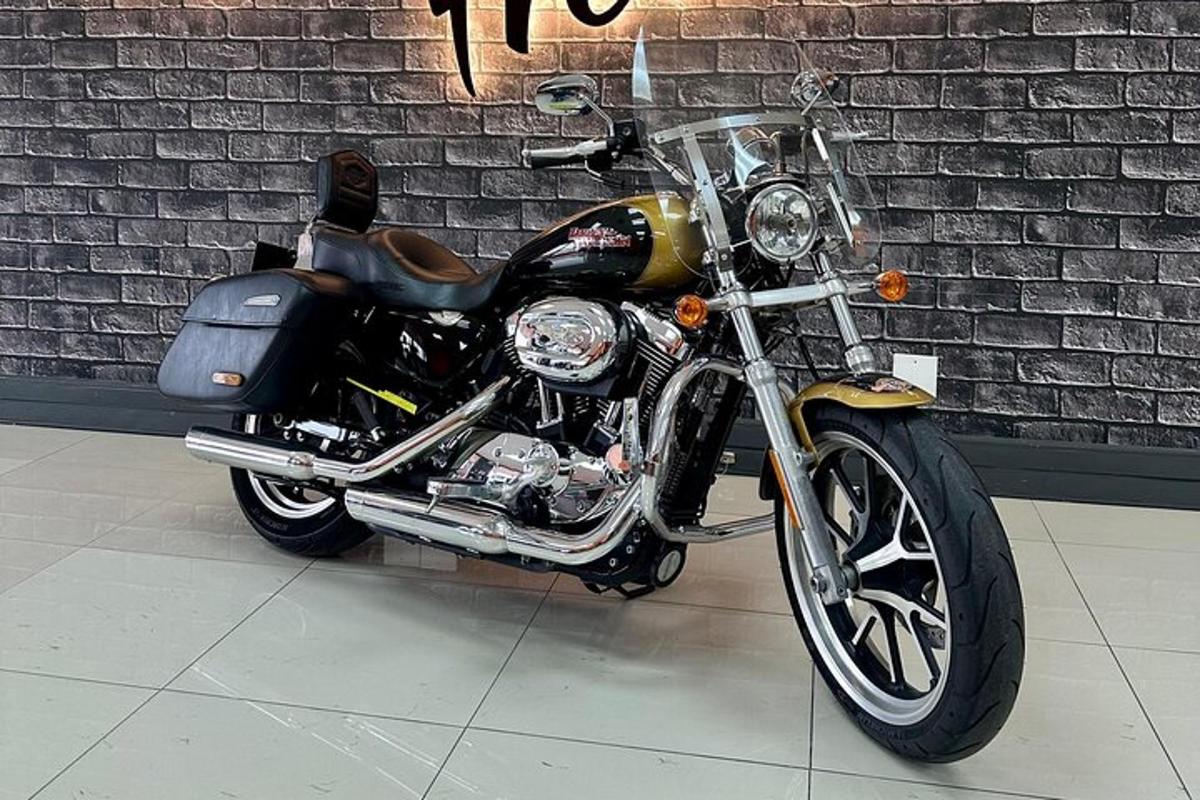 a motorcycle parked next to a brick wall