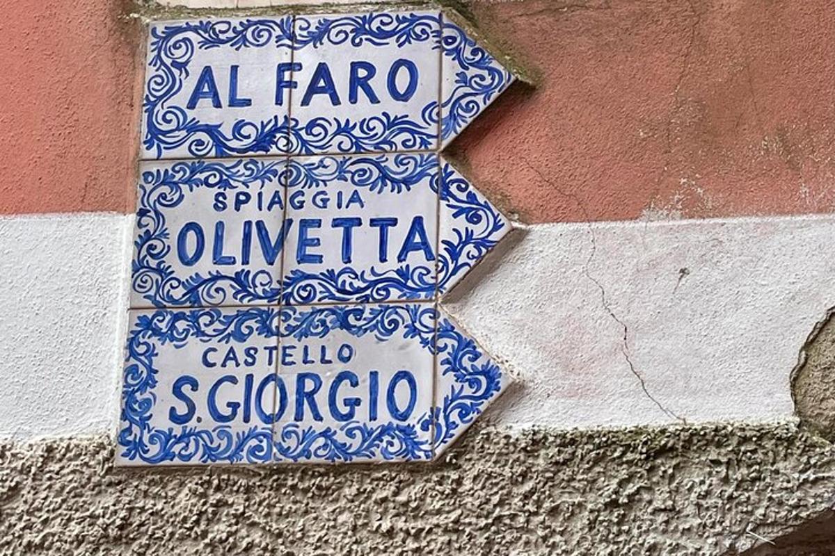 a blue and white street sign on a building