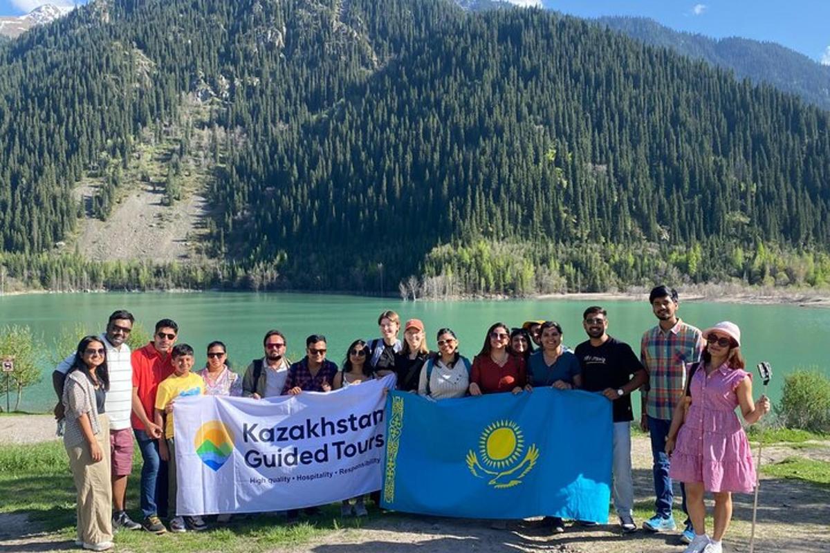 a group of people posing for a picture in front of a lake