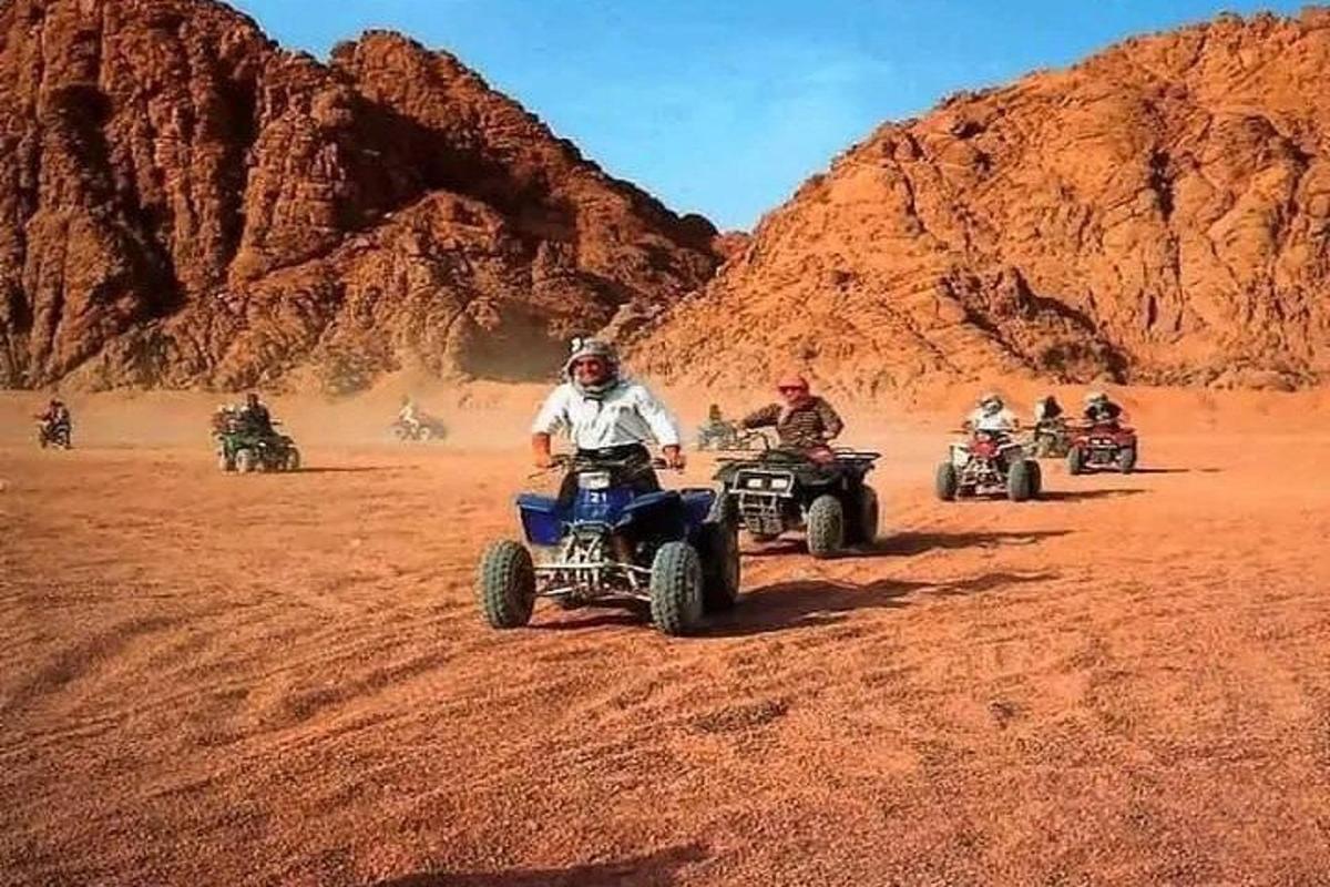 egy csoport ember ATV-zik a sivatagban