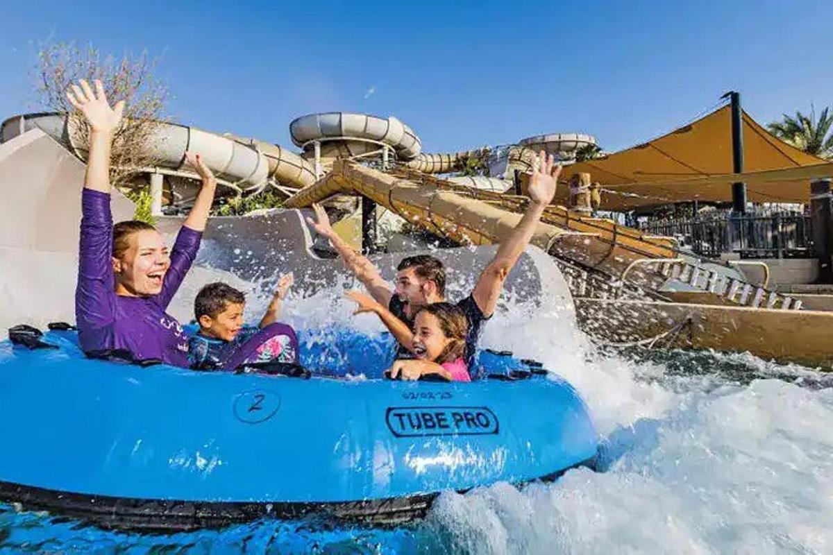 a group of people on a water slide at a water park