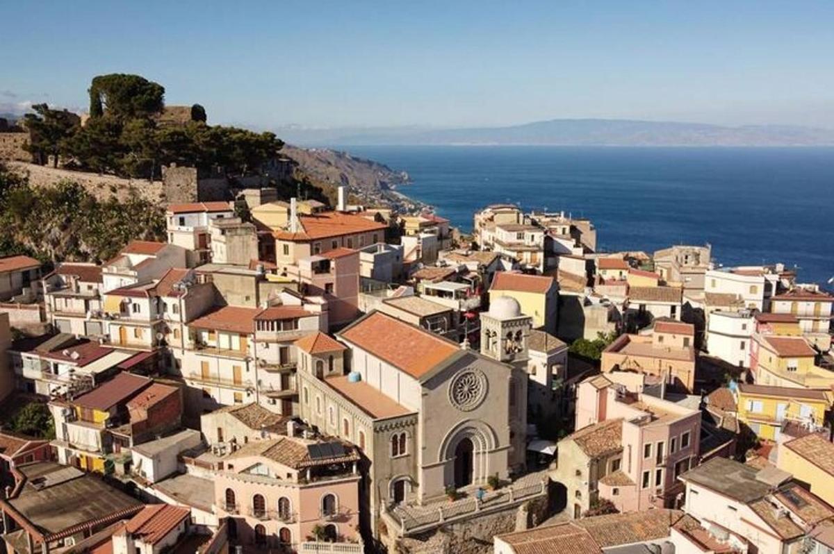 an aerial view of a town with the ocean