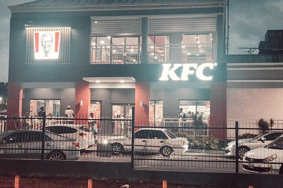 sebuah bangunan kfc dengan kereta diletakkan di luarnya
