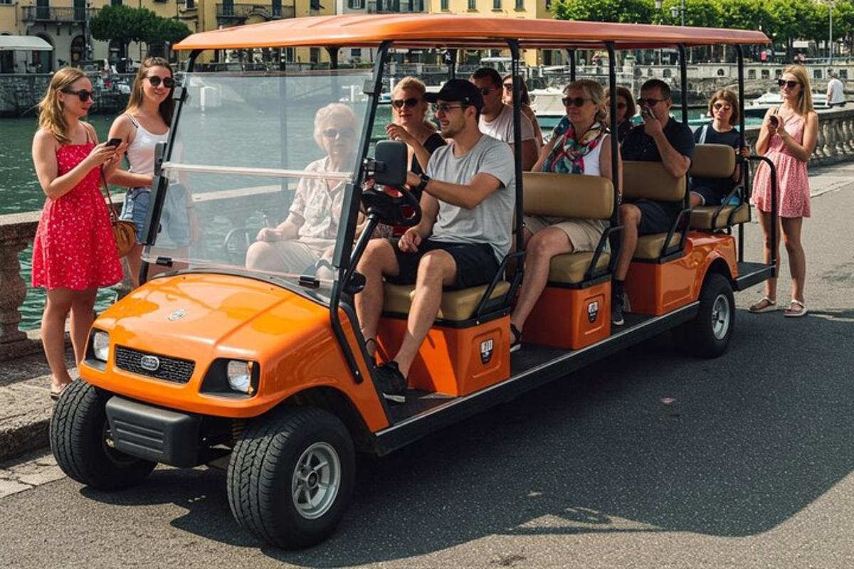 a group of people riding in an orange golf cart