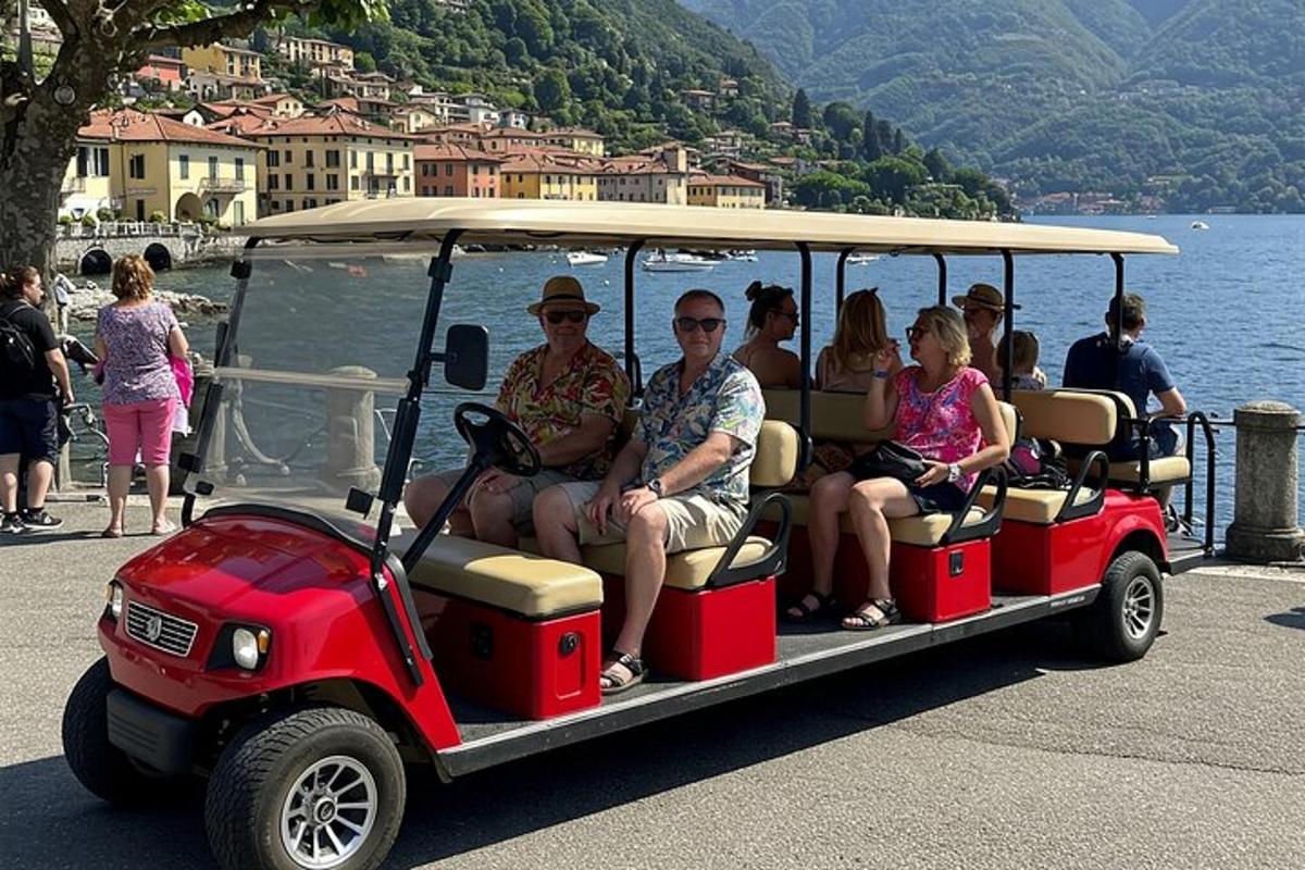 a group of people riding in a golf cart