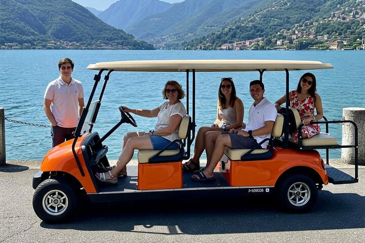a group of people sitting in a golf cart