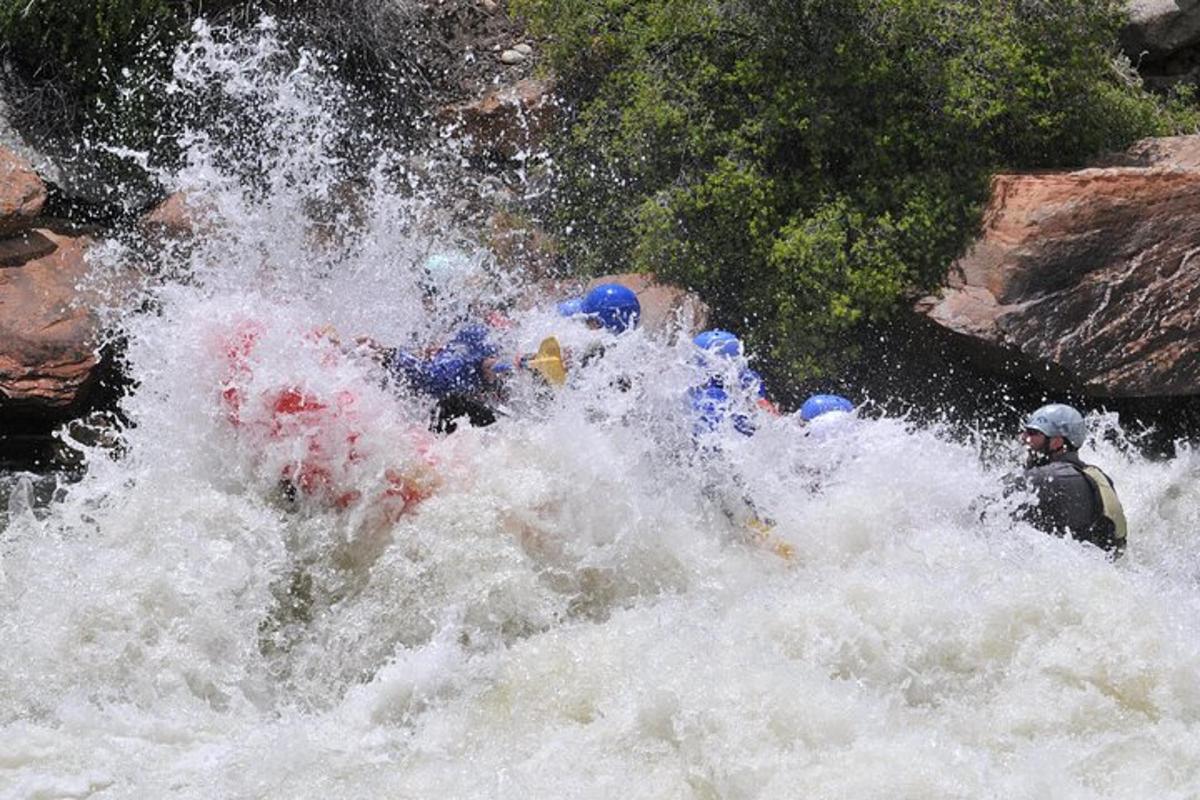 a group of people in a raft in a river