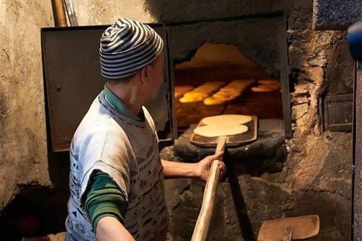 a man is standing in front of an oven