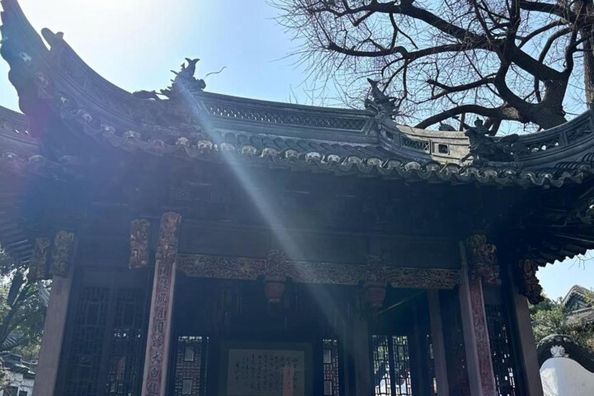 a pagoda with the sun shining through a tree