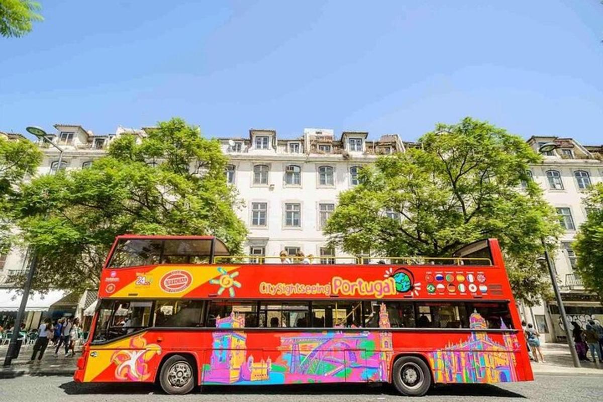 a red double decker bus in front of a building