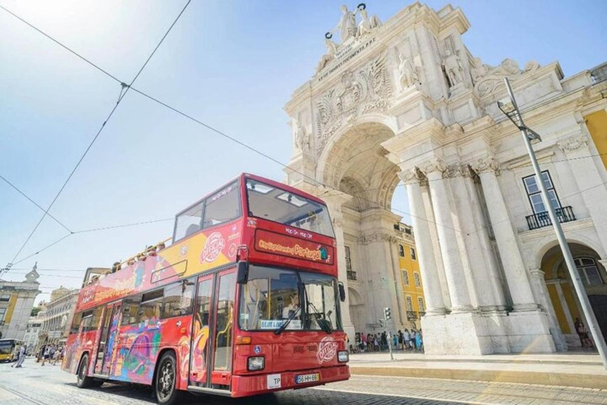 a red double decker bus parked in front of a building
