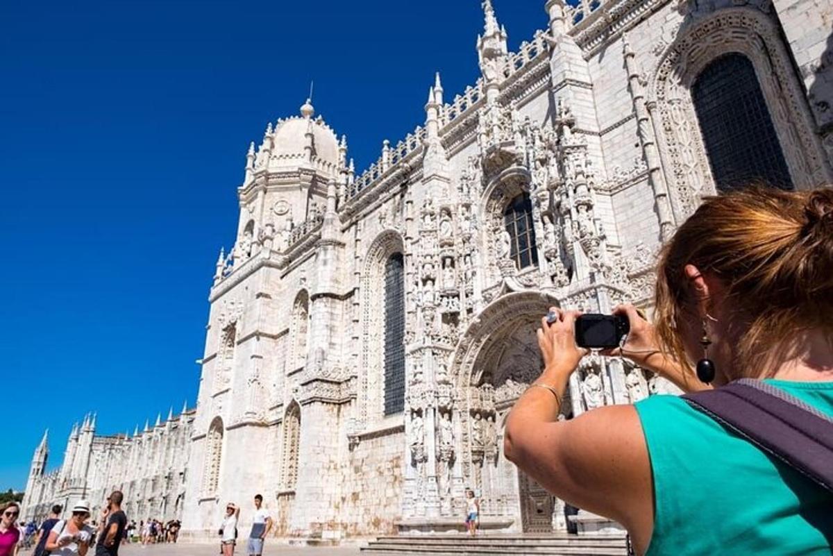 a woman taking a picture of a cathedral