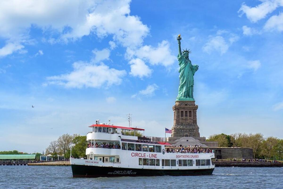 a cruise ship in front of the statue of liberty