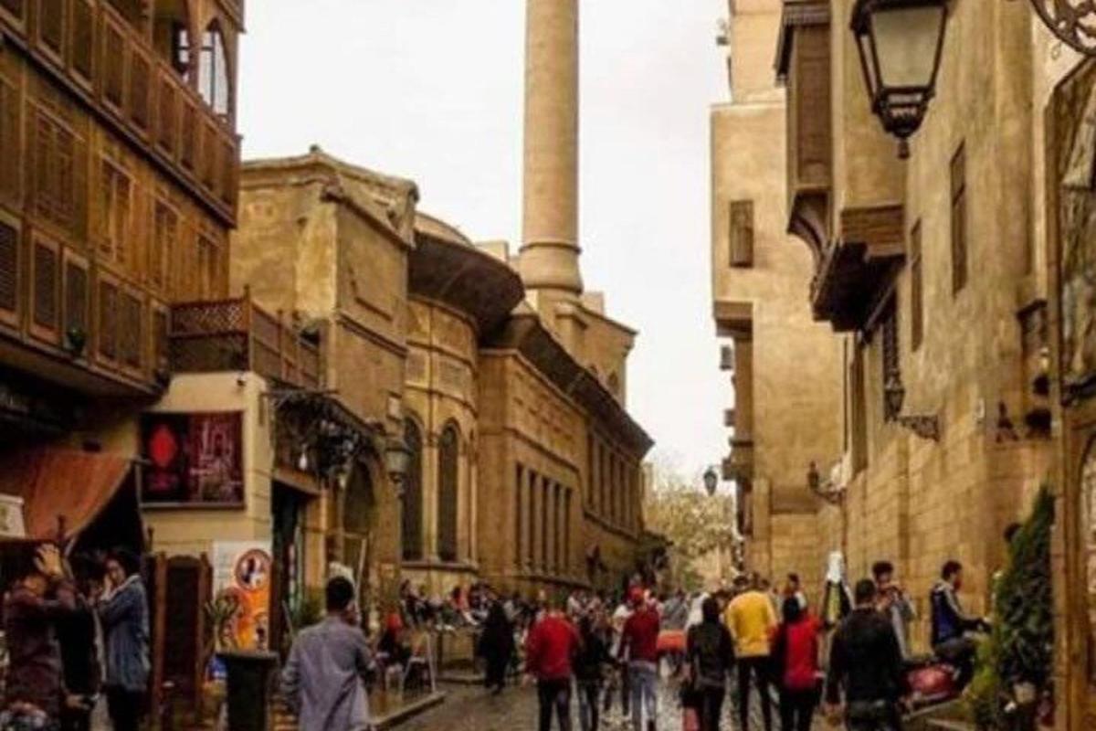 a group of people walking down a city street