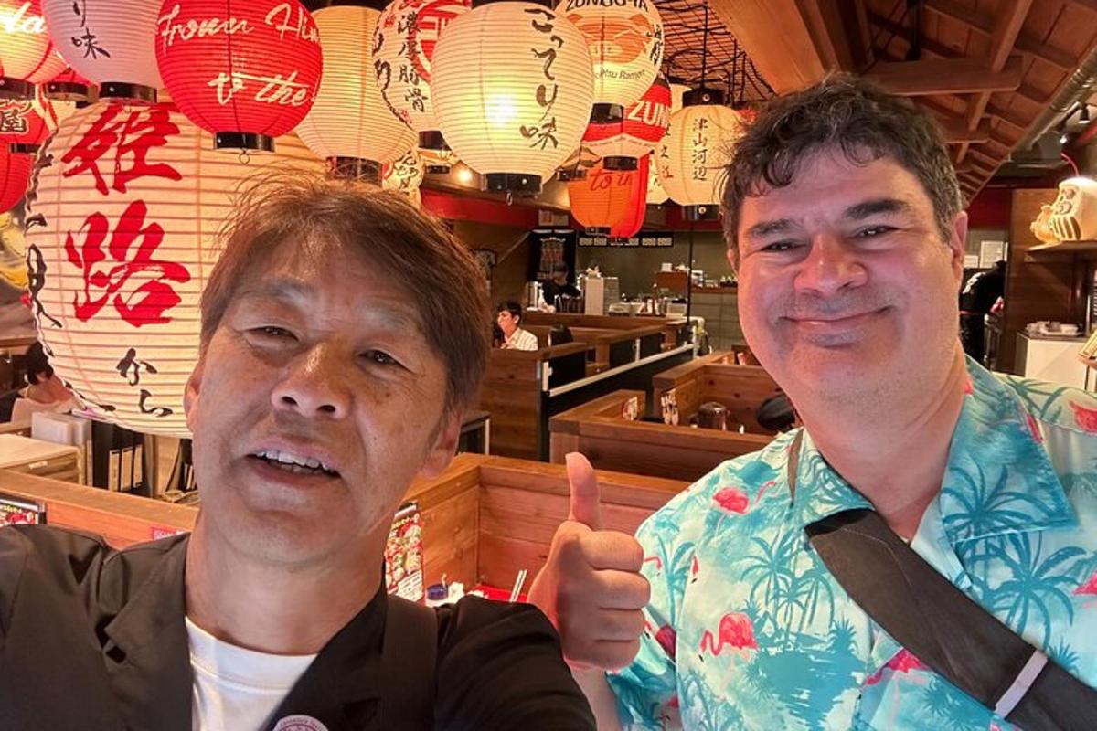 two men giving a thumbs up in a restaurant