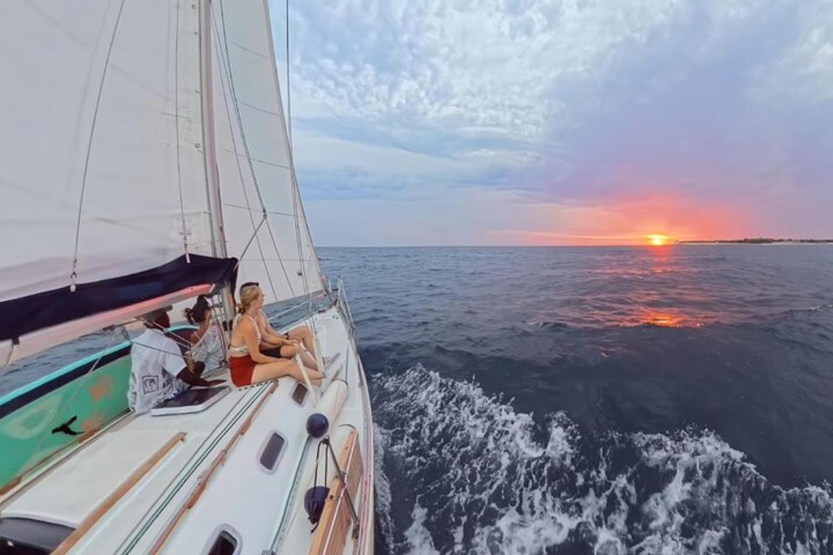 due persone sedute su una barca a vela nell'oceano