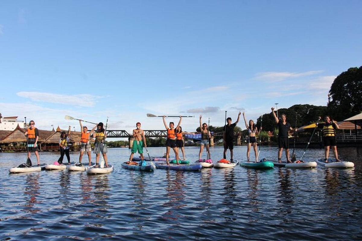 a group of people on paddle boards on the water
