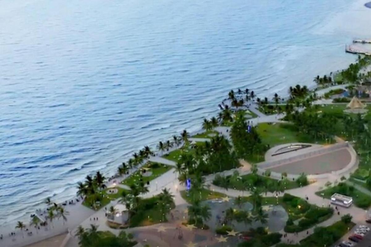 an aerial view of a resort next to the water