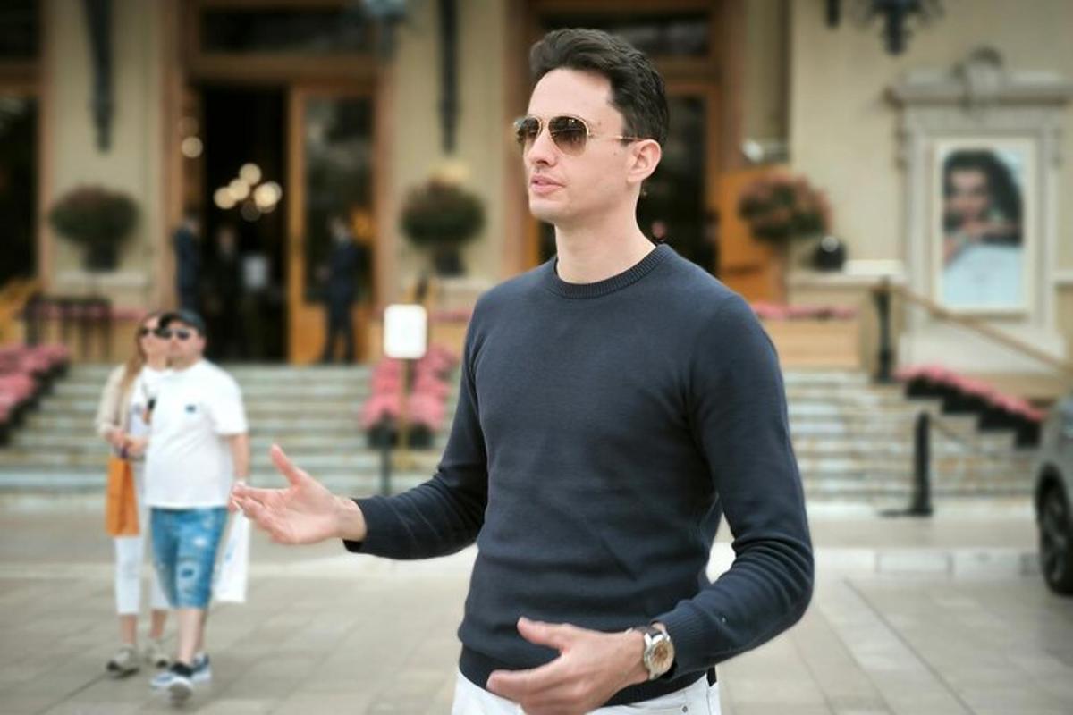 a man standing with his hand out in front of a building