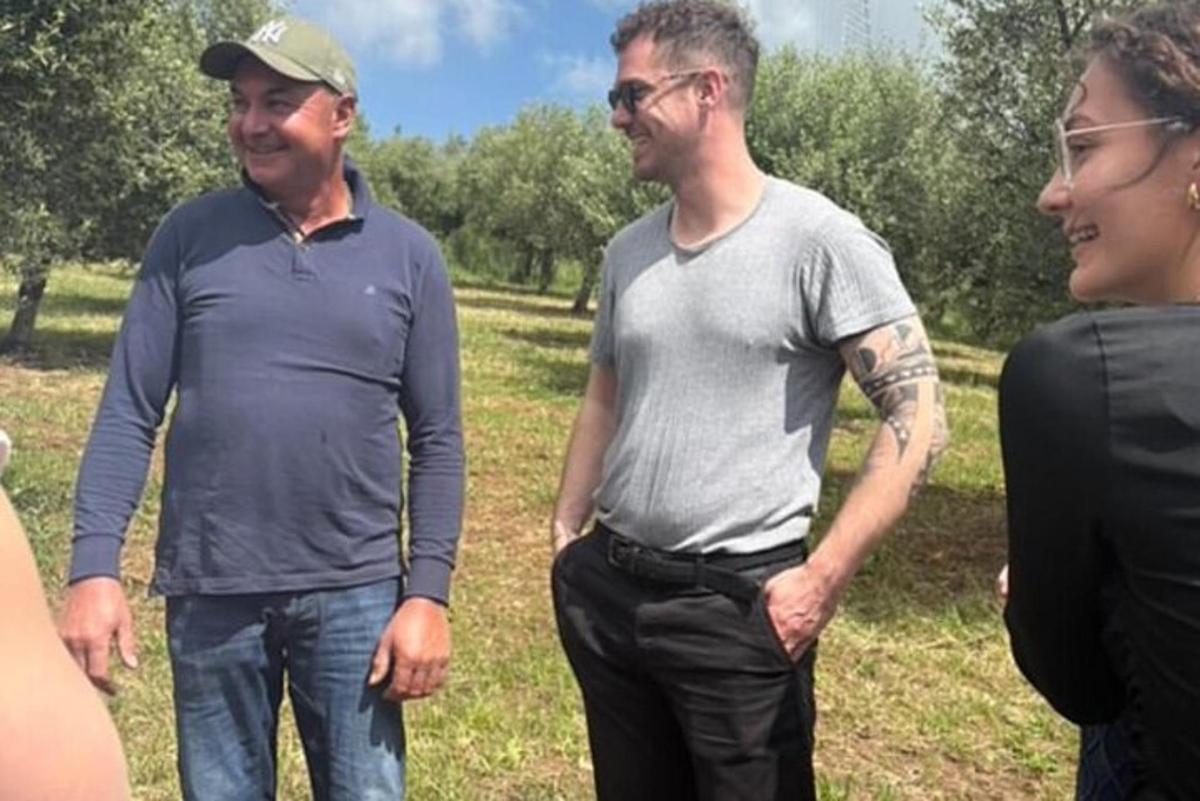 a group of three men standing in a field