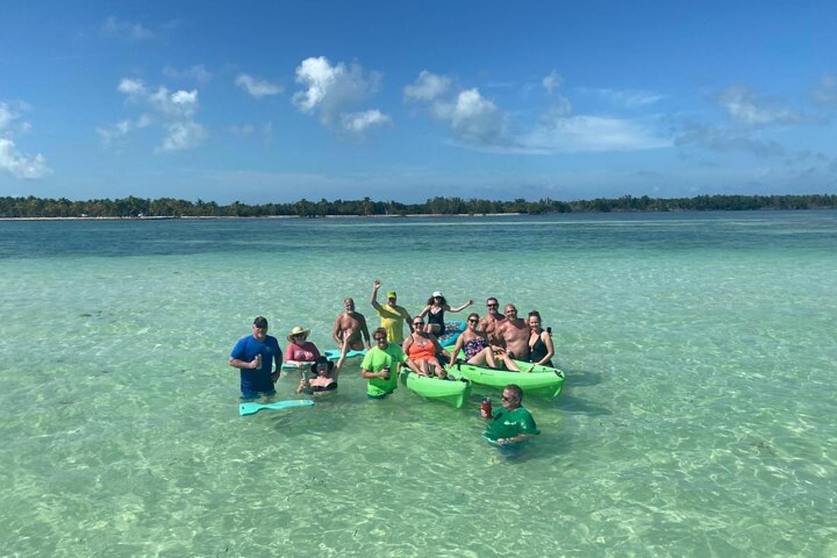 a group of people sitting in the water with canoes