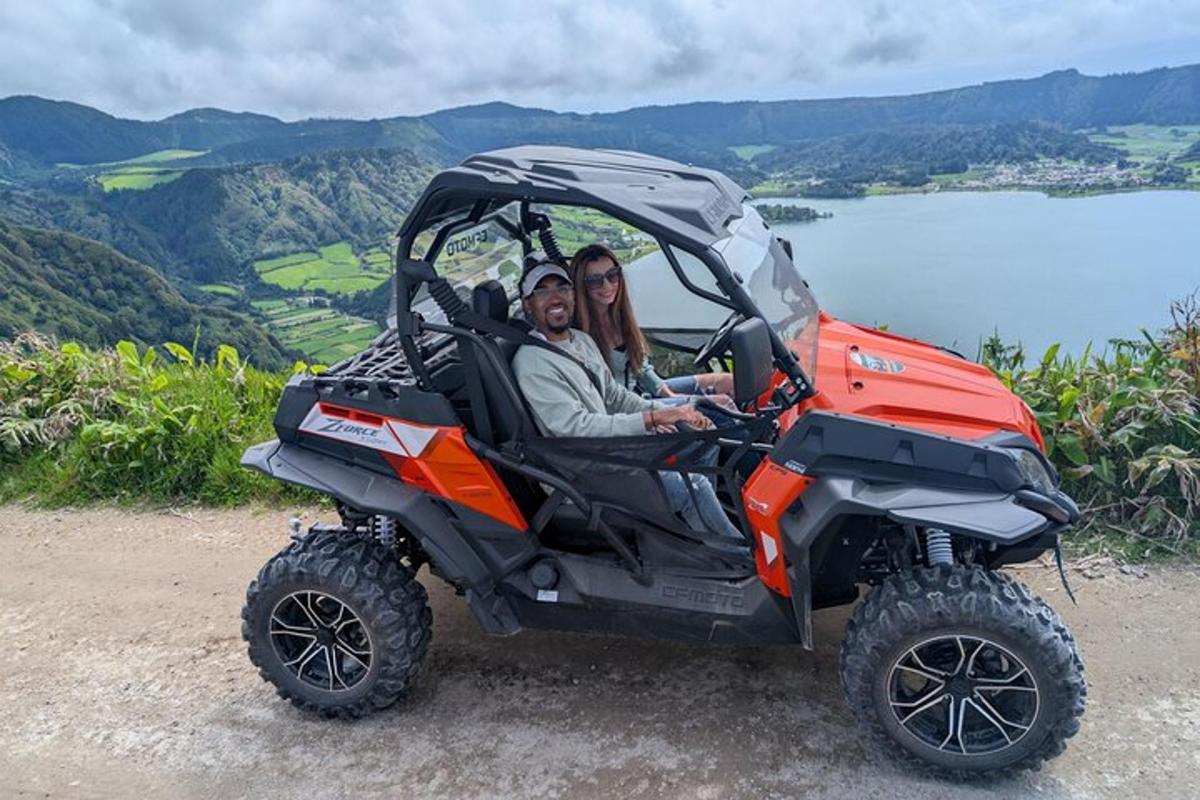 a man and woman sitting in a four wheeler