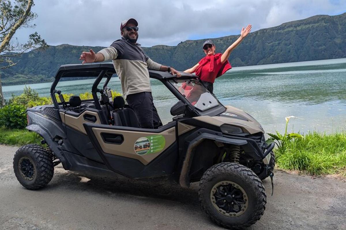 two people standing in the back of a four wheeler
