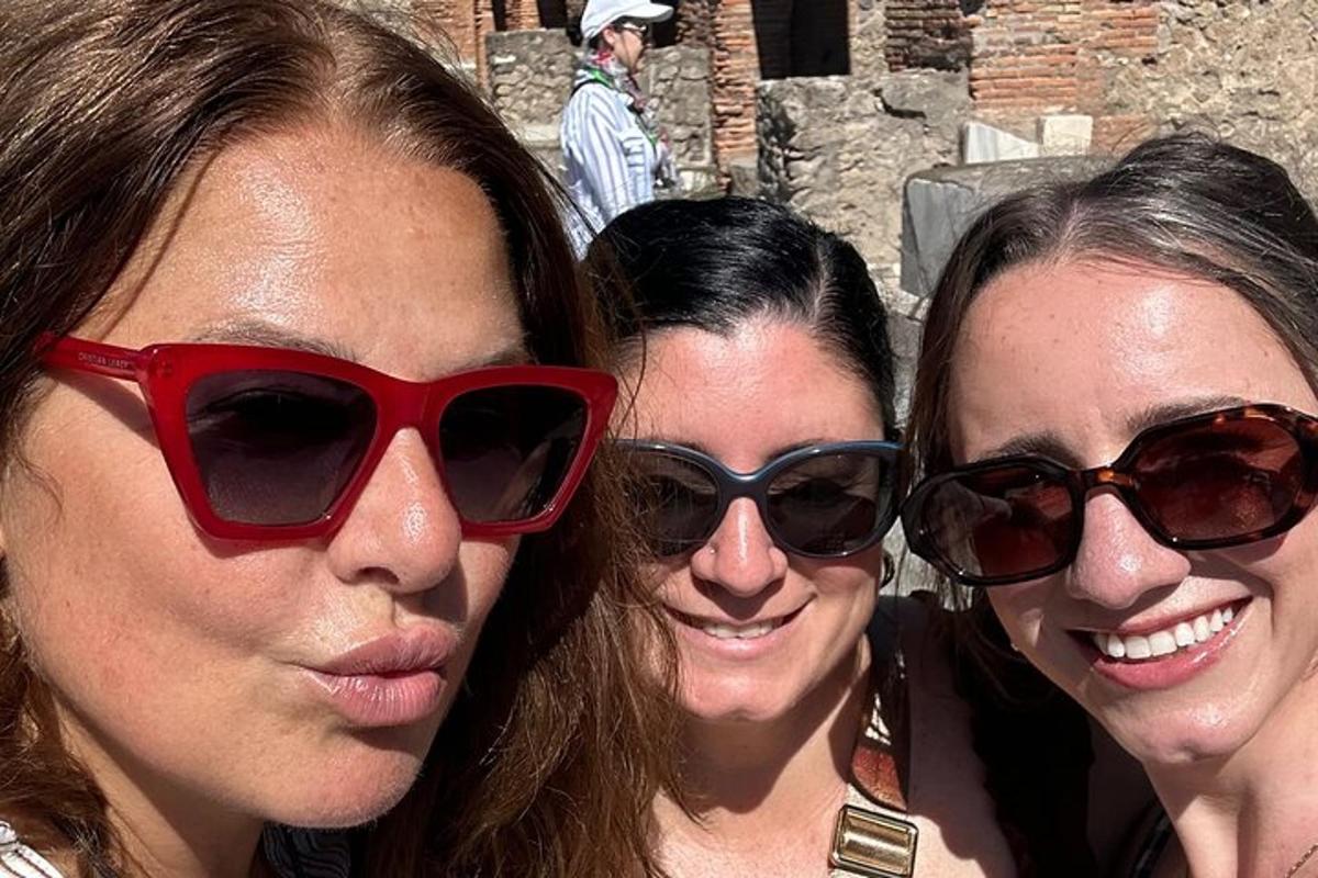 three women wearing sunglasses posing for a picture