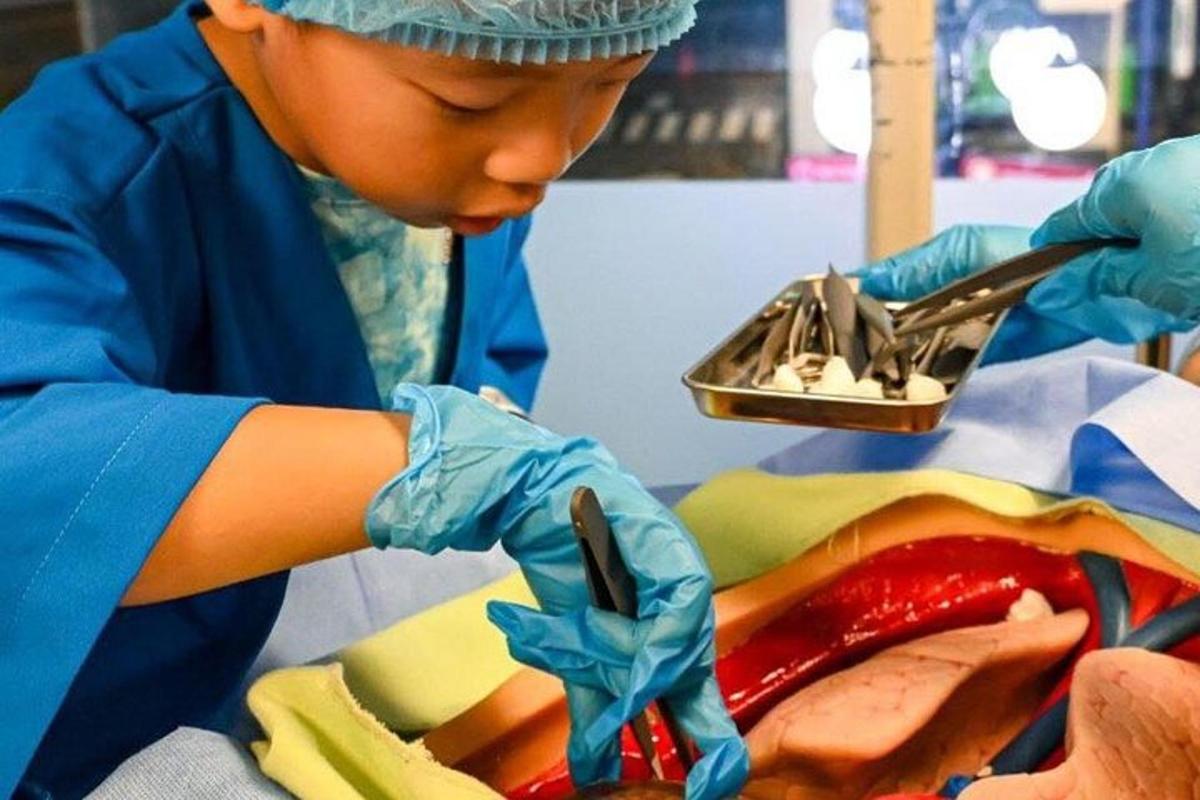a young child in a dental office working on a dental instrument