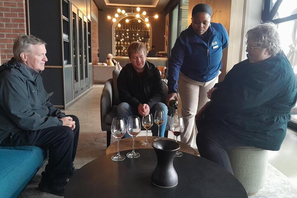 a group of people standing around a table with wine glasses