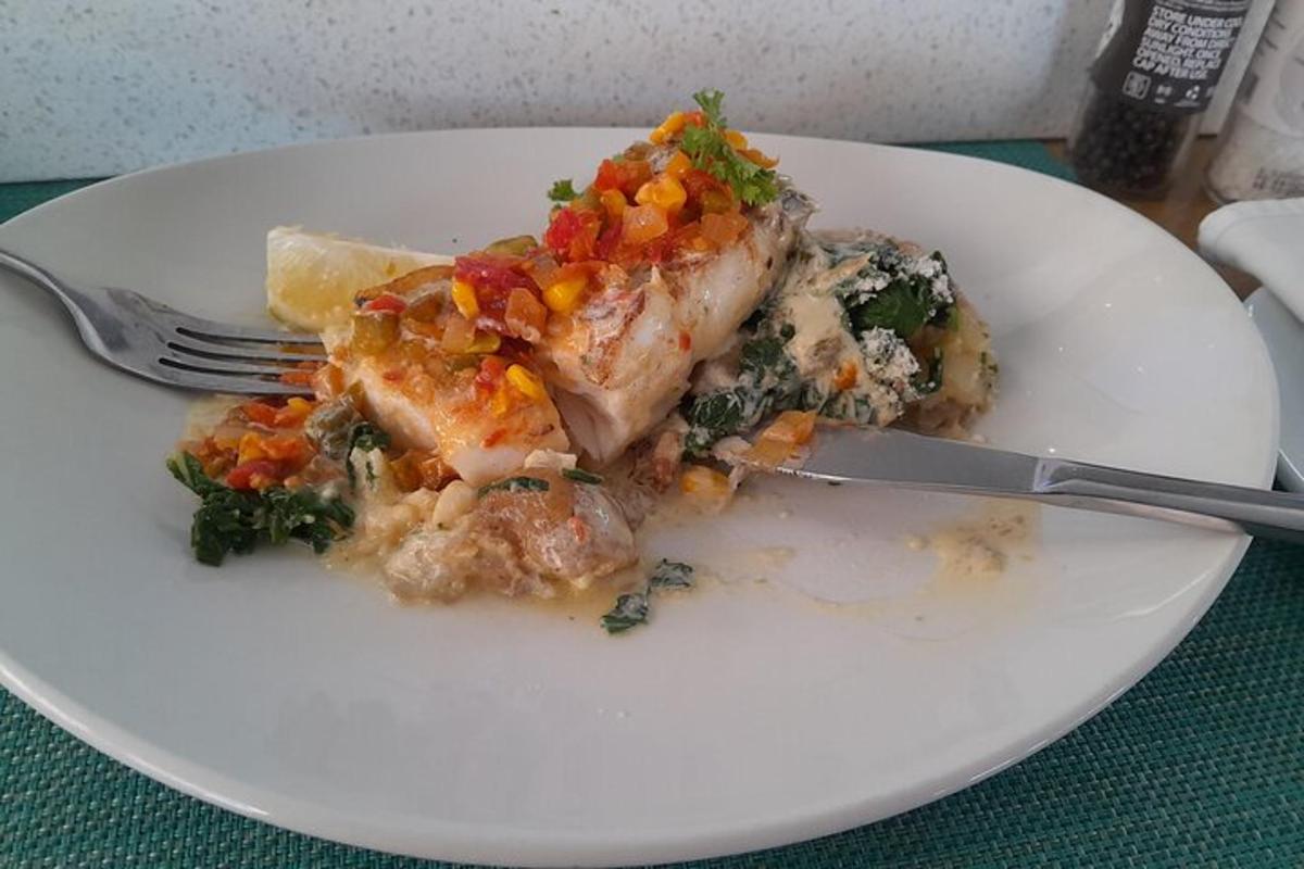 a white plate with a piece of food with a fork