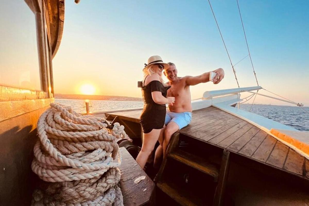 a man and woman standing on the end of a boat