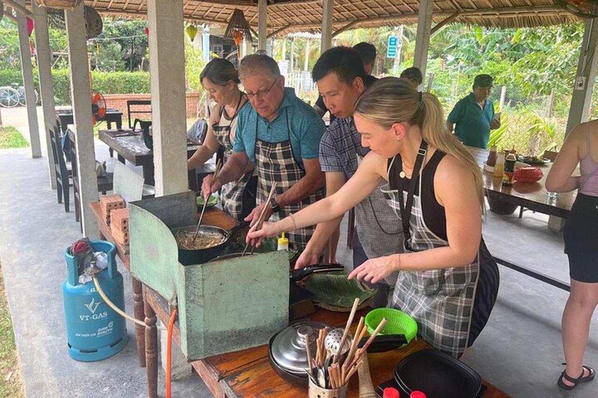 a group of people cooking food in a grill