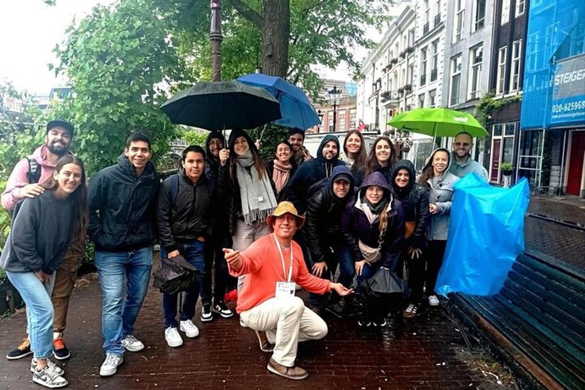 a group of people posing in the rain with umbrellas