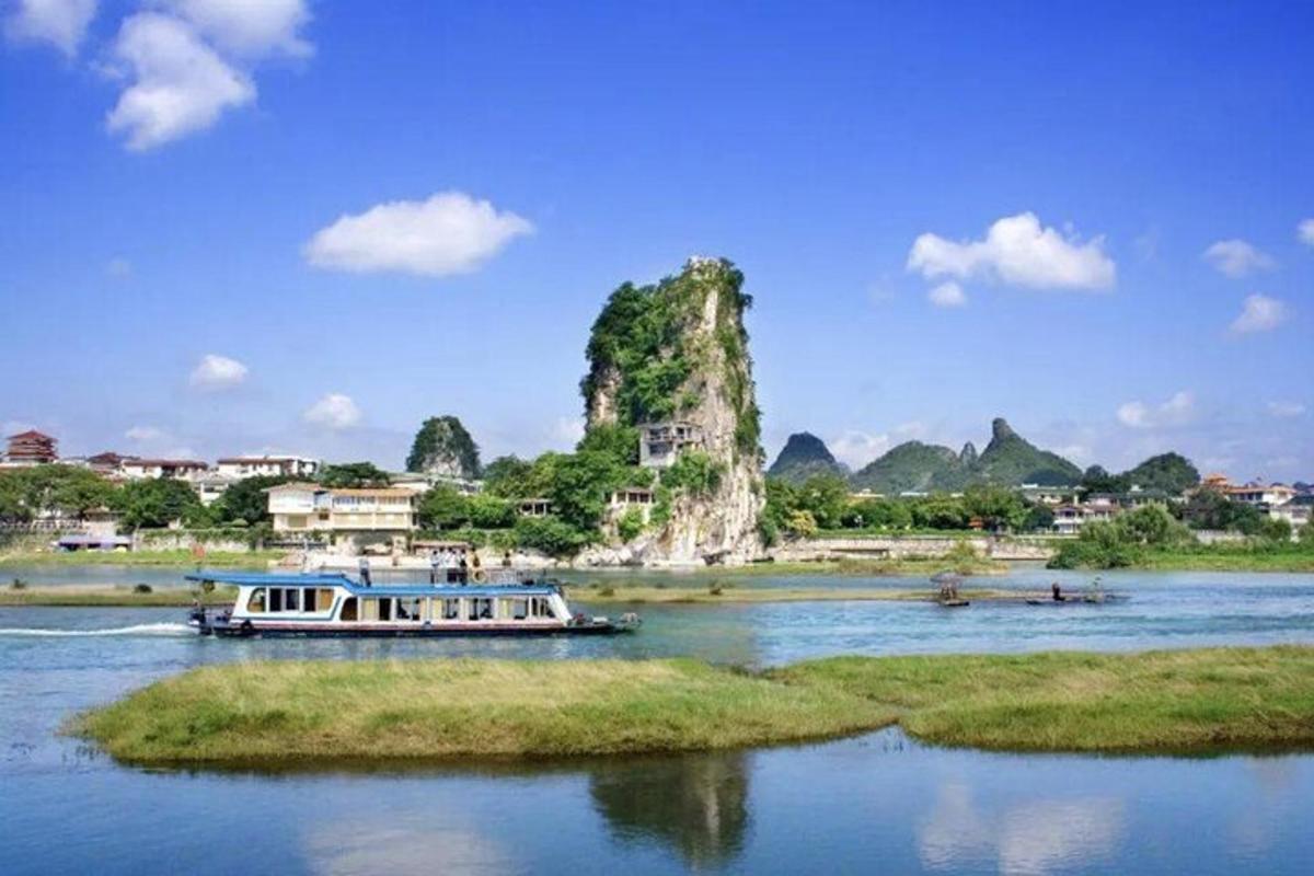 a boat on a river with a mountain in the background