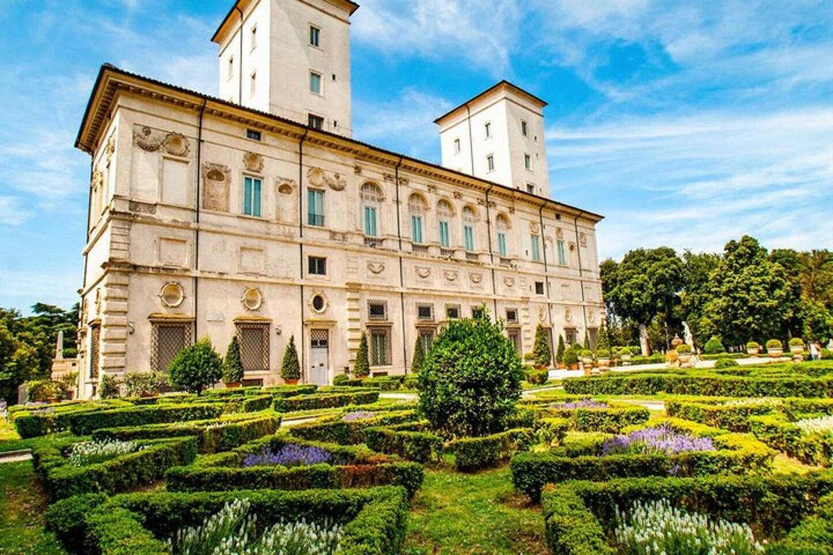 an old building with a garden in front of it
