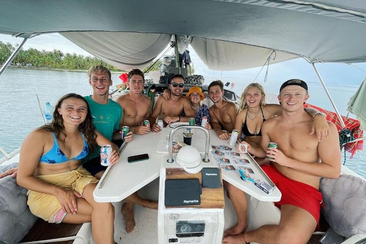 a group of people sitting around a table on a boat