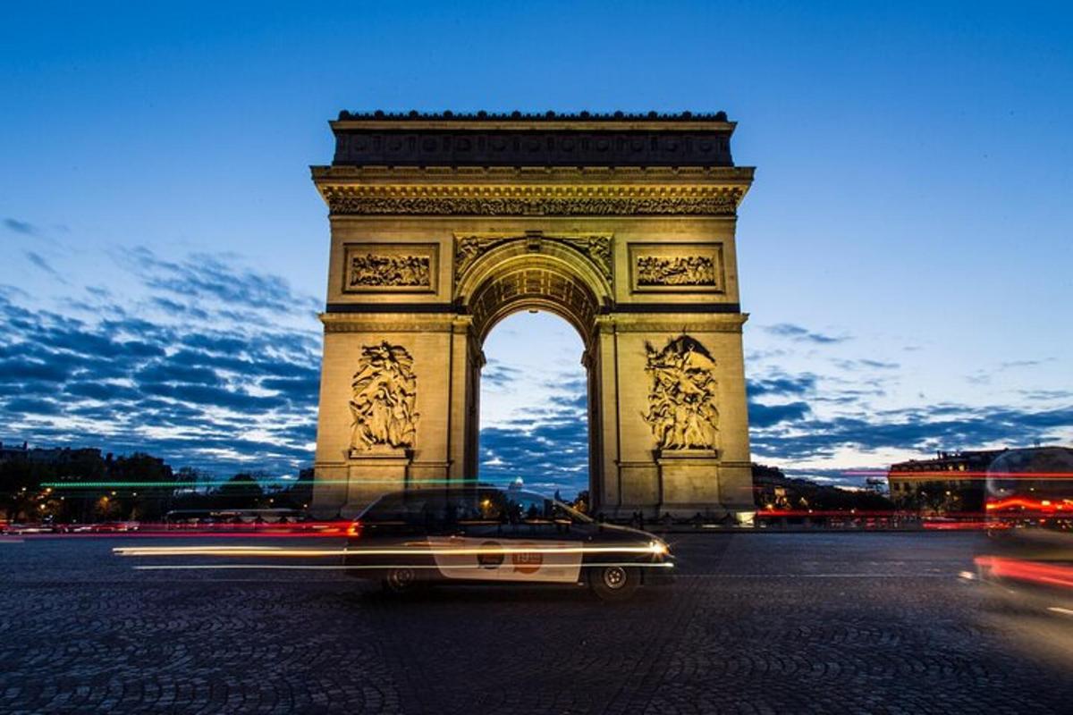 a car driving in front of a large monument