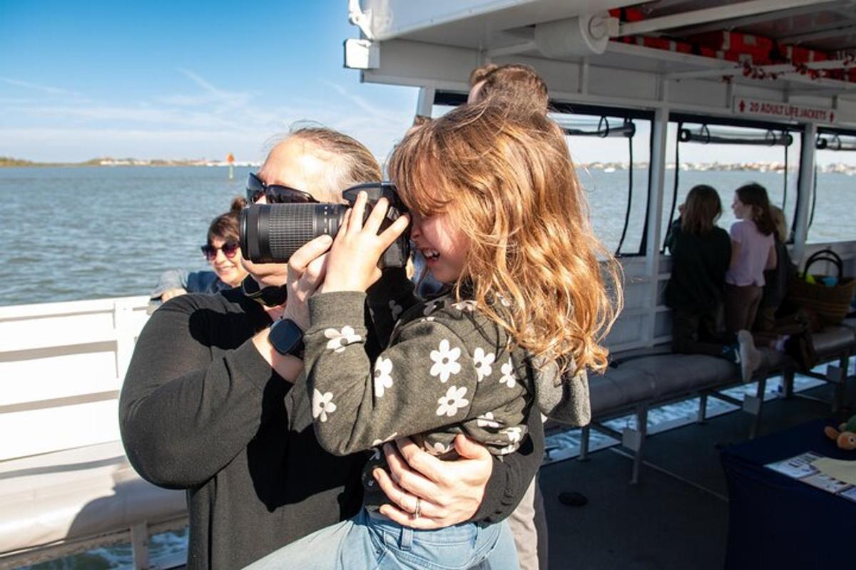 a man taking a picture of a woman on a boat