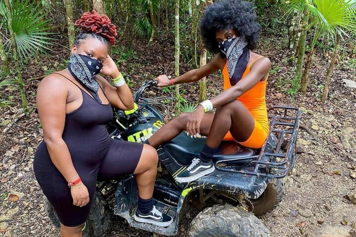 two women are sitting on a dirt bike