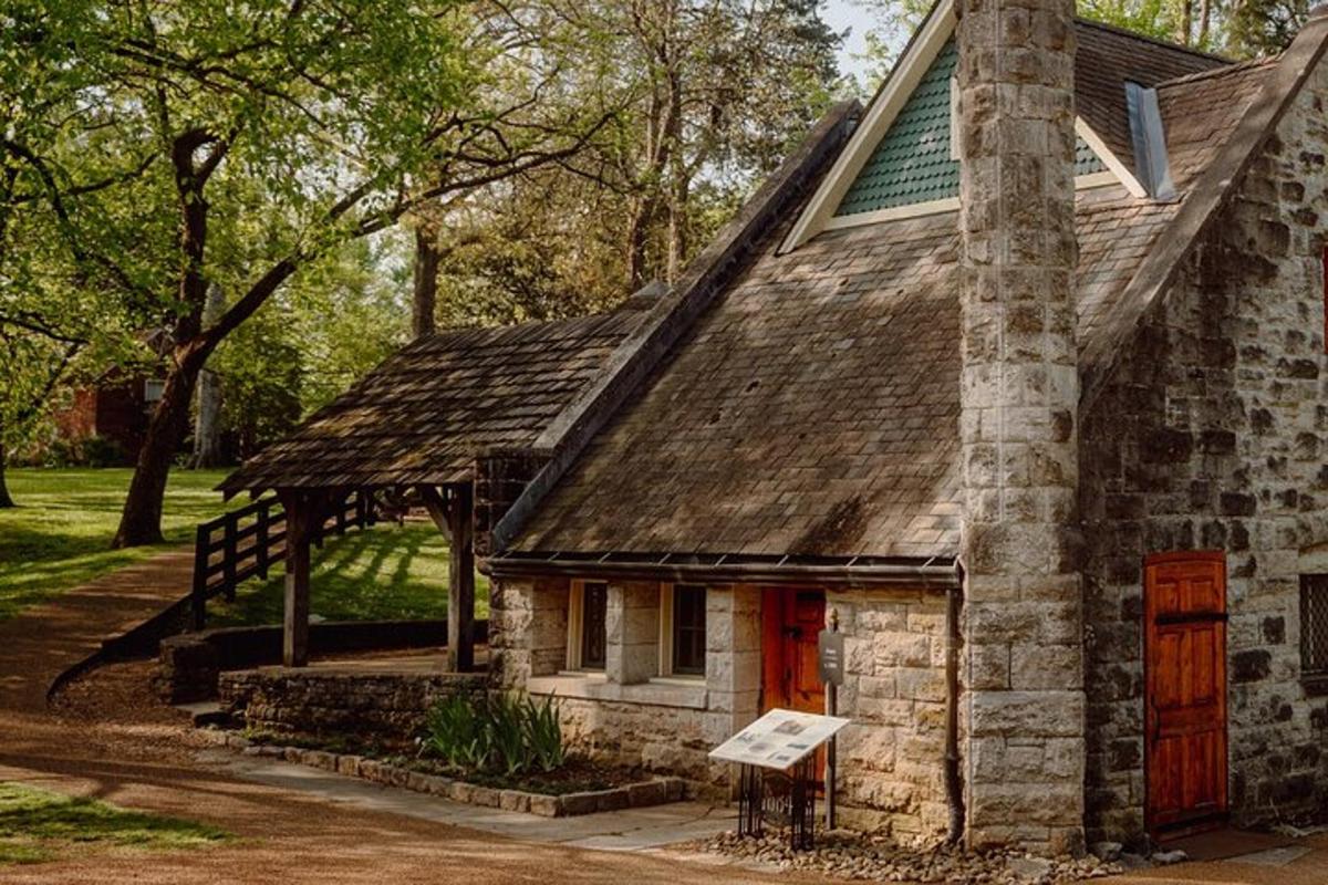an old stone house with a chimney and red door